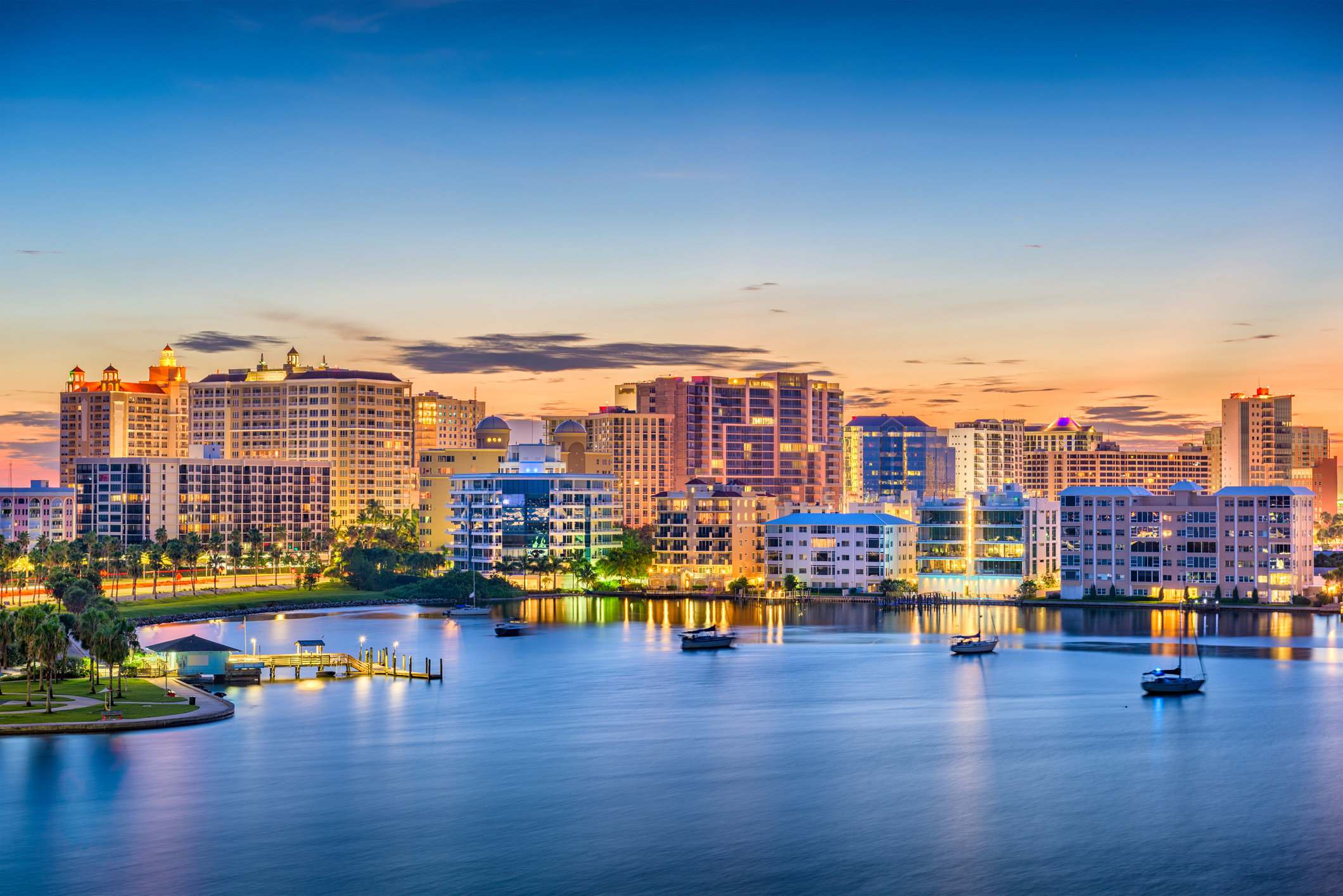 Sarasota skyline at sunset with boats in the bay